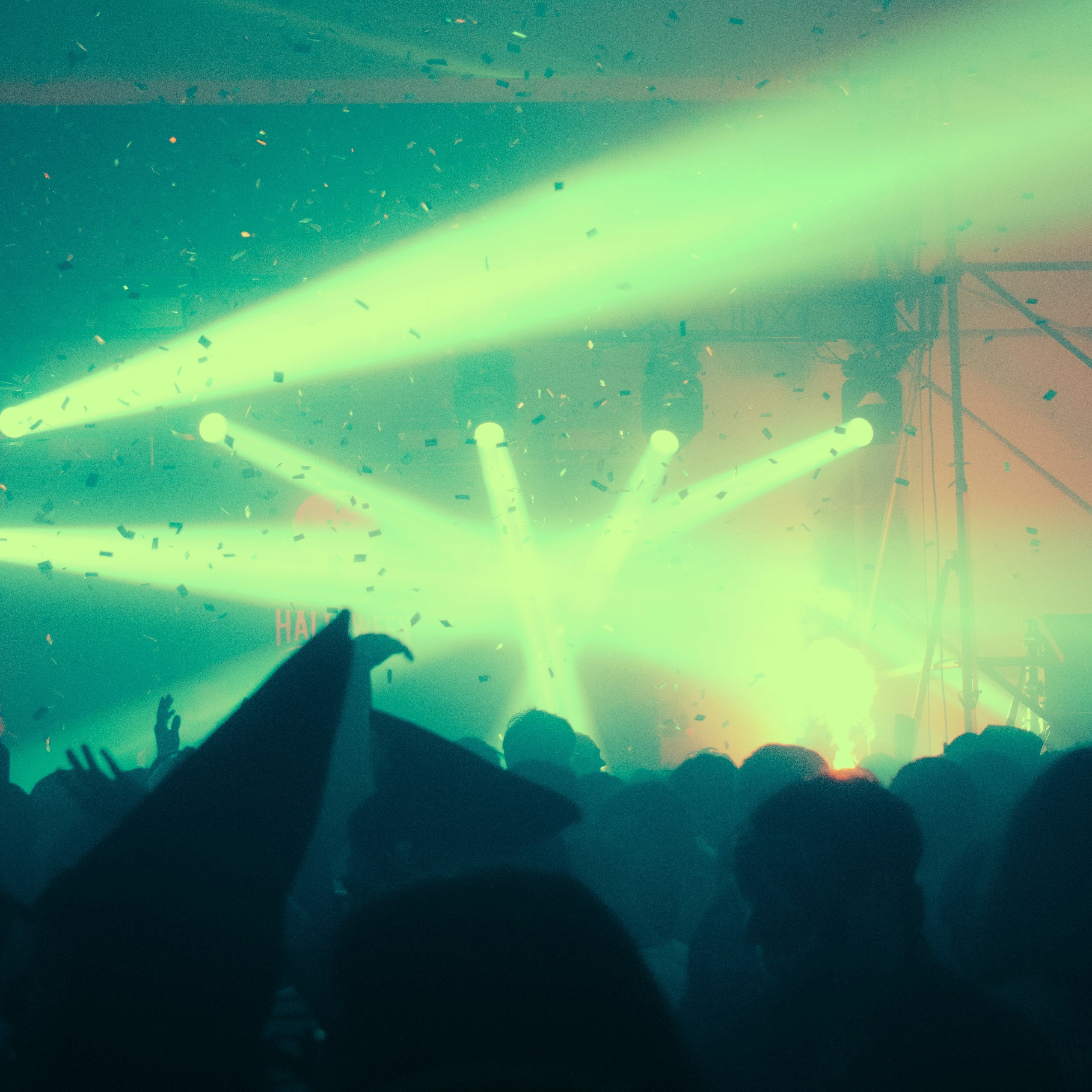 Photo of stage lights with confetti in the air from the crowd