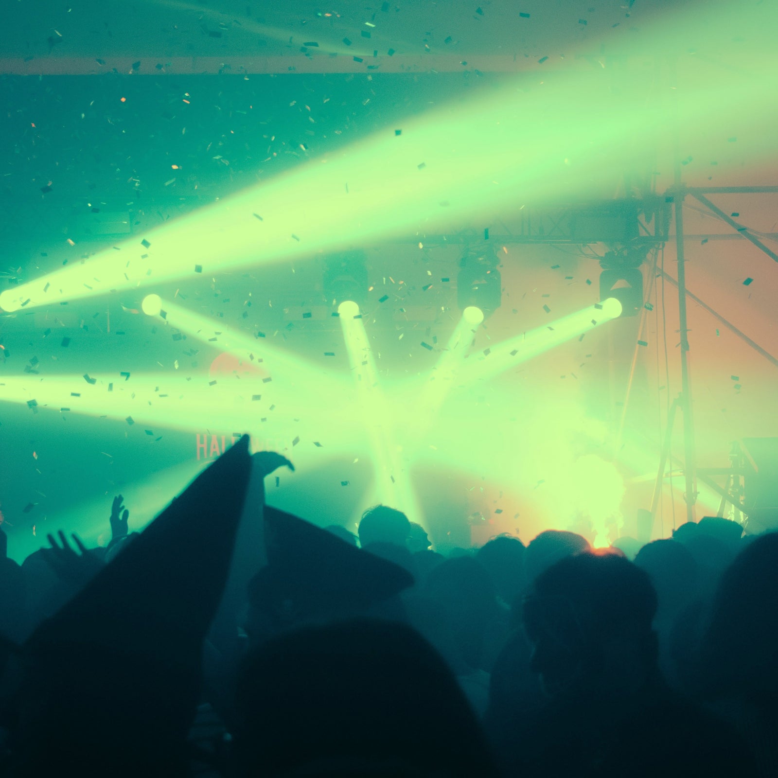 Photo of stage lights with confetti in the air from the crowd